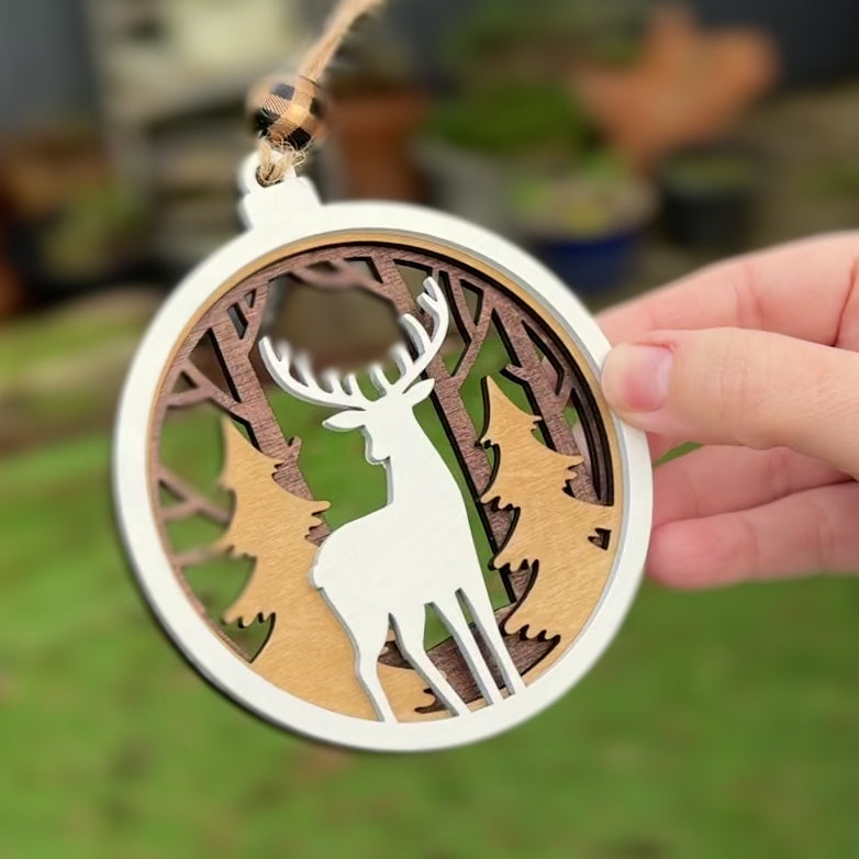 Christmas Tree Decorative ornament with a deer and forest design on a tree.  Hand painted