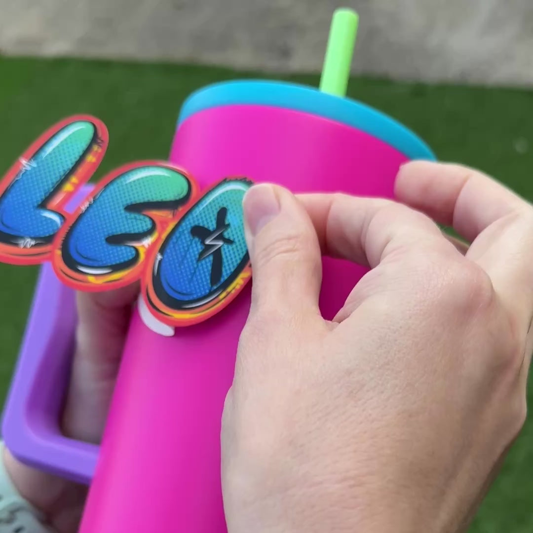Graffiti Personalised Waterproof Vinyl Name Sticker Orange Pink Green Lightning Bolt Applied to bright pink drink bottle