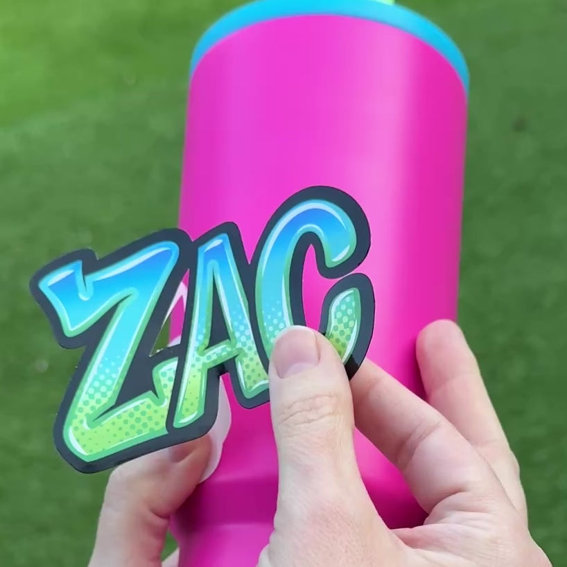 Graffiti Name Personalised Waterproof Vinyl Name Sticker Orange Pink Purple Green Blue Applied to bright pink drink bottle