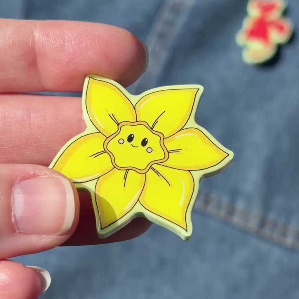 New Welsh Pin collection Daffodil, dragon, leek Dw in hoffi.  Video showing Daffodil pin on green acrylic with a domed front and locking back pin St David's Day