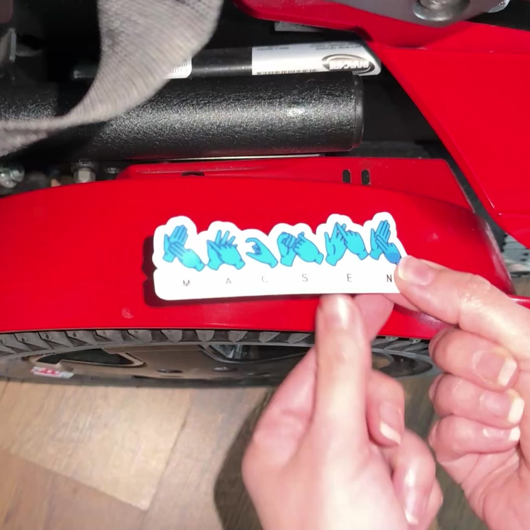 BSL British Sign Language Name Sticker In blue spelling Macsen and applied to an electric wheelchair
